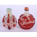 TWO 19TH CENTURY CHINESE PEKING GLASS SNUFF BOTTLES AND STOPPERS decorated with foliage and animals.
