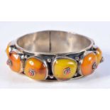 A SILVER AND AMBER BANGLE. 82 grams. 6.5 cm wide.