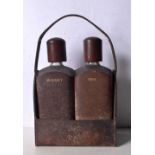 A pair of vintage leather encased glass decanters with purpose made leather carrier. 25 x 20cm (3).