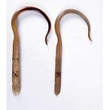 A PAIR OF 19TH CENTURY MIDDLE EASTERN CARVED RHINOCEROS HORN FISH GAFFS. 20 cm long.