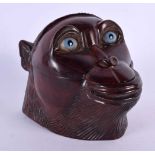 A NOVELTY VICTORIAN CARVED FRUITWOOD INKWELL modelled as a monkey with glass eyes. 11 cm x 8 cm.
