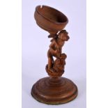 A RARE 19TH CENTURY INDIAN CARVED SANDALWOOD POCKET WATCH HOLDER modelled as a monkey standing