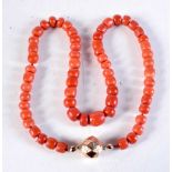 A VICTORIAN 15CT GOLD AND CORAL NECKLACE. 84.2 grams. 57 cm long.