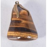 A CONTINENTAL CARVED TIGERS EYE PENDANT. 5 cm x 3 cm.