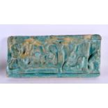 A 12TH / 13TH CENTURY PERSIAN KASHAN POTTERY TURQUOISE TILE with raised calligraphy central with a