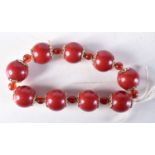 A CHERRY AMBER TYPE RED BEAD BRACELET. 26 grams. 5.25 cm wide.