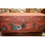 A 19TH CENTURY CHINESE CARVED AND RED LACQUERED CABINET Qing, fitted with three greenish white
