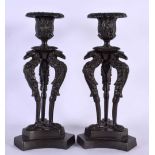 A PAIR OF 19TH CENTURY EUROPEAN BRONZE CANDLESTICKS formed with bird heads. 21 cm high.