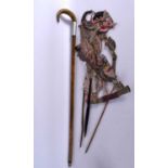 AN ANTIQUE MIDDLE EASTERN CARVED RHINOCEROS HORN WALKING CANE together with a puppet. Largest 90