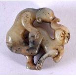 A CHINESE CARVED MUTTON JADE EROTIC ROUNDEL 20th Century. 5 cm wide.