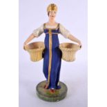 A 19TH CENTURY RUSSIAN PORCELAIN FIGURE OF A FEMALE modelled holding two baskets. 24 cm x 12 cm.