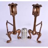 A LOVELY PAIR OF ARTS AND CRAFTS STYLISED ANDIRONS formed with shield panels upon organic