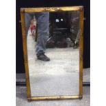 An antique gilt wood over mantle mirror 76 x 46 cm.