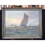 A framed oil on board depicting a sailing barge on the sea. 59 x 79cm.