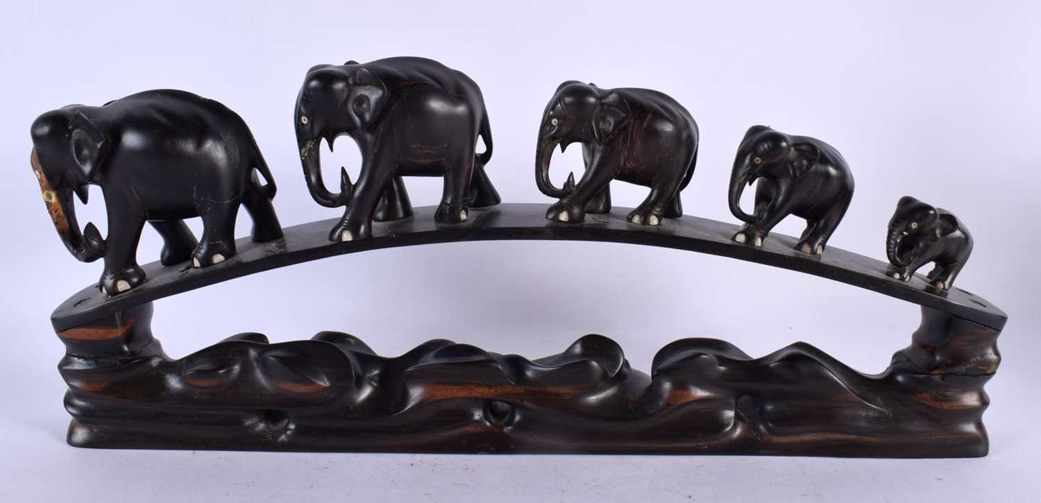 A LATE 19TH CENTURY ANGLO INDIAN CARVED HARDWOOD ELEPHANT GROUP modelled roaming. 45 cm x 20 cm.