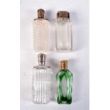 FOUR ANTIQUE SILVER TOPPED SCENT BOTTLES. Largest 12 cm x 3 cm. (4)