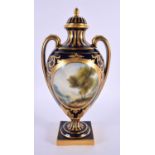 Royal Worcester two handled vase and cover painted with two figures in a landscape by Harry Davis,