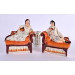 A PAIR OF 19TH CENTURY STAFFORDSHIRE FIGURES OF A MALE AND FEMALE modelled upon a sofa. 22 cm x 17