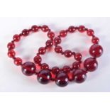 A CHERRY AMBER TYPE NECKLACE. 111 grams. 63 cm long.