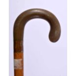 A LARGE 19TH CENTURY MIDDLE EASTERN CARVED RHINOCEROS HORN HANDLED WALKING CANE. 90 cm long.