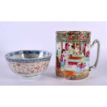 A 19TH CENTURY CHINESE CANTON FAMILLE ROSE MUG Qing, together with a rice bowl. Largest 12 cm x 12