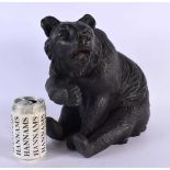 A 19TH CENTURY BAVARIAN BLACK FOREST FIGURE OF A BEAR modelled seated with arm raised. 30 cm x 24