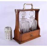 AN ANTIQUE OAK TWIN BOTTLE GLASS TANTALUS. 34 cm x 20 cm.