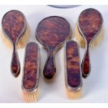 AN ART DECO SILVER AND TORTOISESHELL BRUSH SET. 800 grams overall. Largest 27 cm x 18 cm. (5)