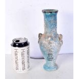 An Islamic blue glazed pottery vase. 23 cm.