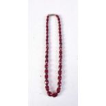 A RED AMBER TYPE BEAD NECKLACE. 15 grams. 42 cm long.