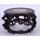 A CHINESE CARVED HARDWOOD STAND 20th Century, inset with a jade roundel. 12 cm x 8 cm.