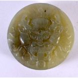 AN EARLY 20TH CENTURY CHINESE CARVED GREEN JADE MASK BUCKLE Late Qing/Republic. 5.5 cm wide.