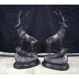 A large pair of bronze stags mounted on a marble plinth