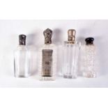 FOUR ANTIQUE SILVER TOPPED SCENT BOTTLES. Largest 9 cm x 3 cm. (4)