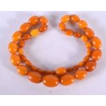 AN ART DECO MIDDLE EASTERN AMBER NECKLACE. 52.8 grams. 61 cm long, largest bead 2.5 cm x 1.75 cm.