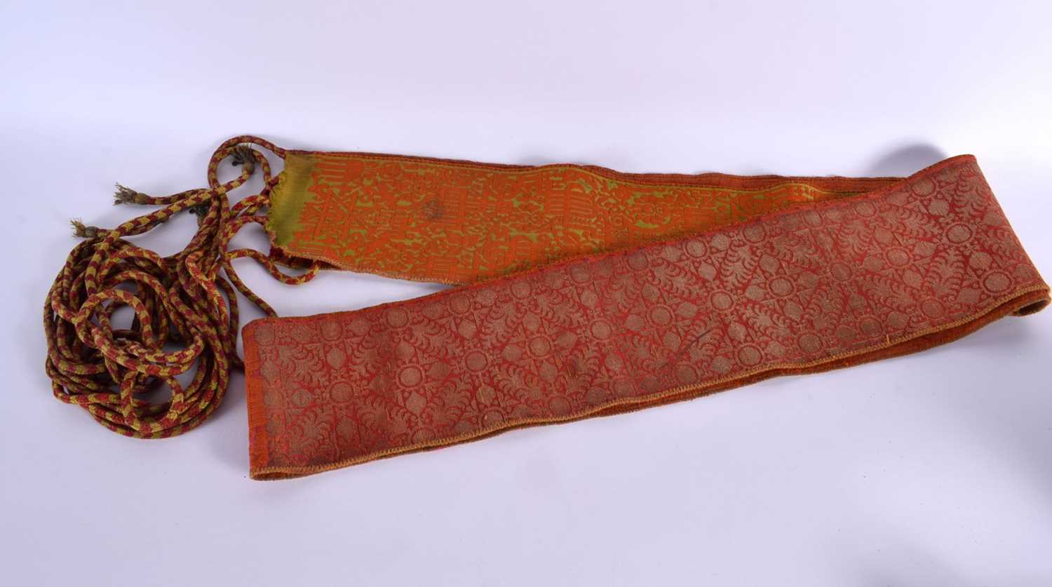 A 19TH CENTURY TURKISH ORANGE AND RED SILK EMBROIDERED BELT decorated with gold motifs. 280 cm