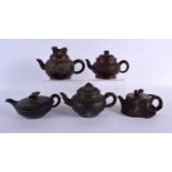 FIVE CHINESE YIXING POTTERY TEAPOT AND COVERS. Largest 15 cm wide. (5)