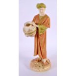 AN ANTIQUE BLUSH IVORY FIGURE OF A WATER CARRIER. 22.5 cm high.