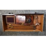 A collection of antique photographic items, including cameras, plate holders and tripod stands. (