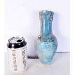 An Islamic blue glazed pottery vase. 22 cm.