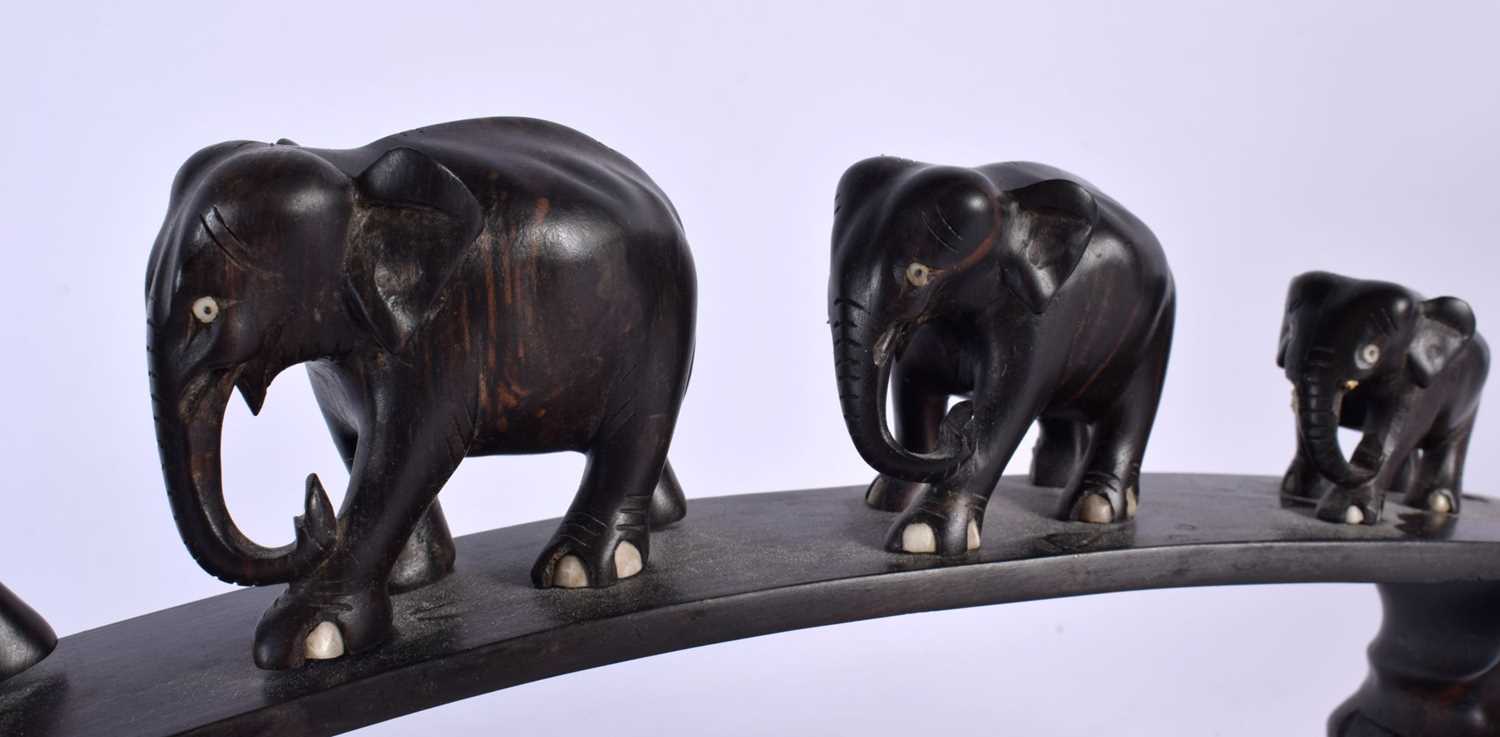 A LATE 19TH CENTURY ANGLO INDIAN CARVED HARDWOOD ELEPHANT GROUP modelled roaming. 45 cm x 20 cm. - Image 3 of 5