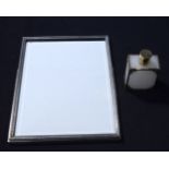 A SILVER MOUNTED SCENT BOTTLE and a frame. Largest 27 cm x 21 cm. (2)