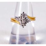 A 10CT GOLD AND DIAMOND CLUSTER RING. 2.9 grams. O.