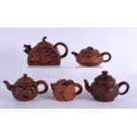 FIVE CHINESE YIXING POTTERY TEAPOT AND COVERS. Largest 15 cm wide. (5)
