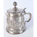 A LARGE 19TH CENTURY CONTINENTAL SILVER REPOUSSE STEIN decorated with cupids within landscapes. 1047