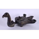 A 19TH CENTURY MIDDLE EASTERN SILVER INLAID BRONZE OIL LAMP formed as a bird, decorated with motifs.