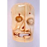 A JAPANESE CARVED BONE ANATOMICAL SKULL MASK. 5 cm x 3 cm.