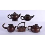 FIVE CHINESE YIXING POTTERY TEAPOT AND COVERS. Largest 15 cm wide. (5)