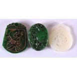 THREE CHINESE CARVED JADE PENDANTS 20th Century. Largest 5.75 cm x 4.5 cm. (3)