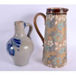 AN ANTIQUE DOULTON LAMBETH JUG together with a stoneware jug. Largest 21 cm high. (2)